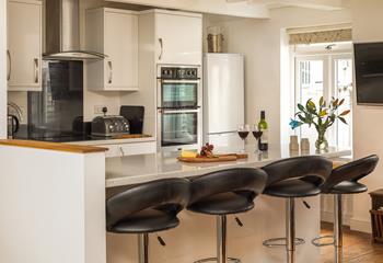 The stylish kitchen is perfectly equipped to rustle up delicious meals.
