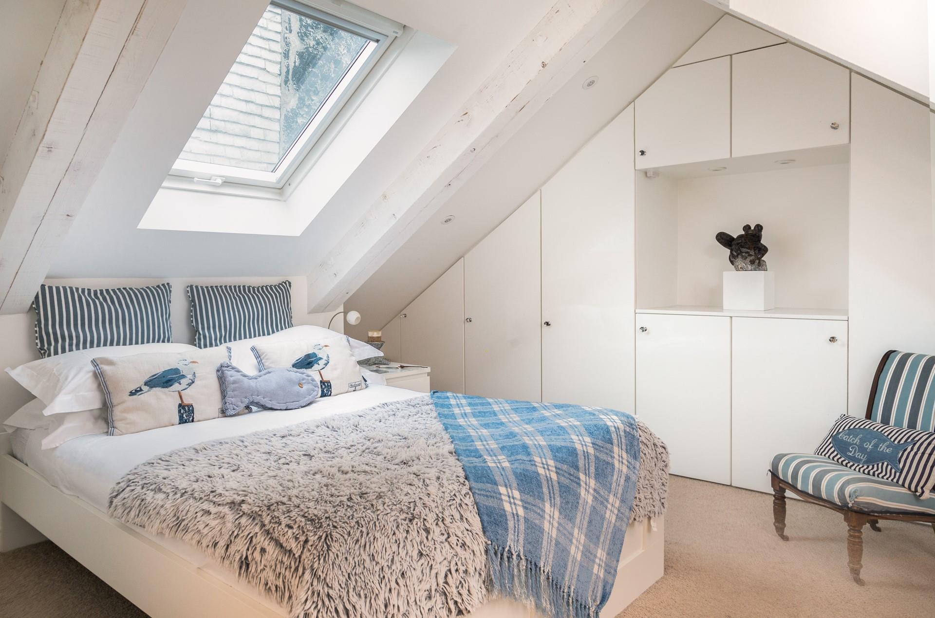The first floor double bedroom has an en-suite and features cosy interiors for a relaxing night's sleep.