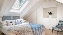 The first floor double bedroom has an en-suite and features cosy interiors for a relaxing night's sleep.