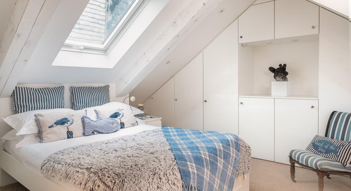 The first floor double bedroom has an en-suite and features cosy interiors for a relaxing night's sleep.