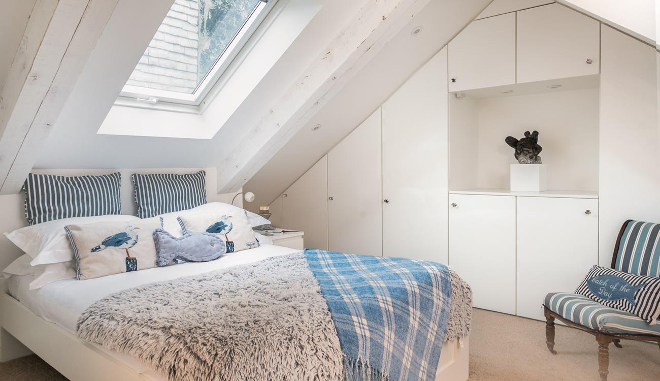 The first floor double bedroom has an en-suite and features cosy interiors for a relaxing night's sleep.