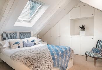 The first floor double bedroom has an en-suite and features cosy interiors for a relaxing night's sleep.