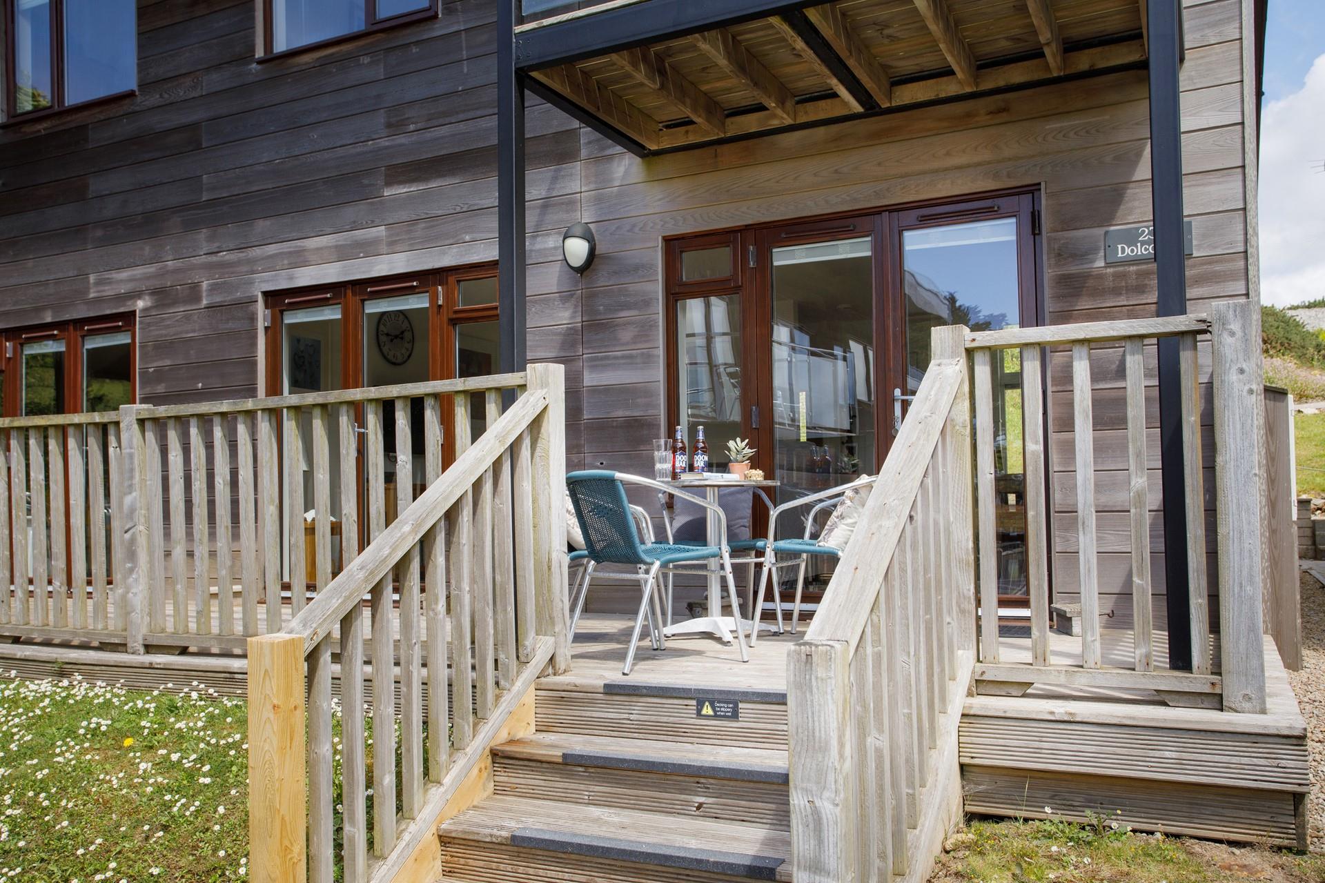 Five external wooden steps lead to the decked area and front door. 