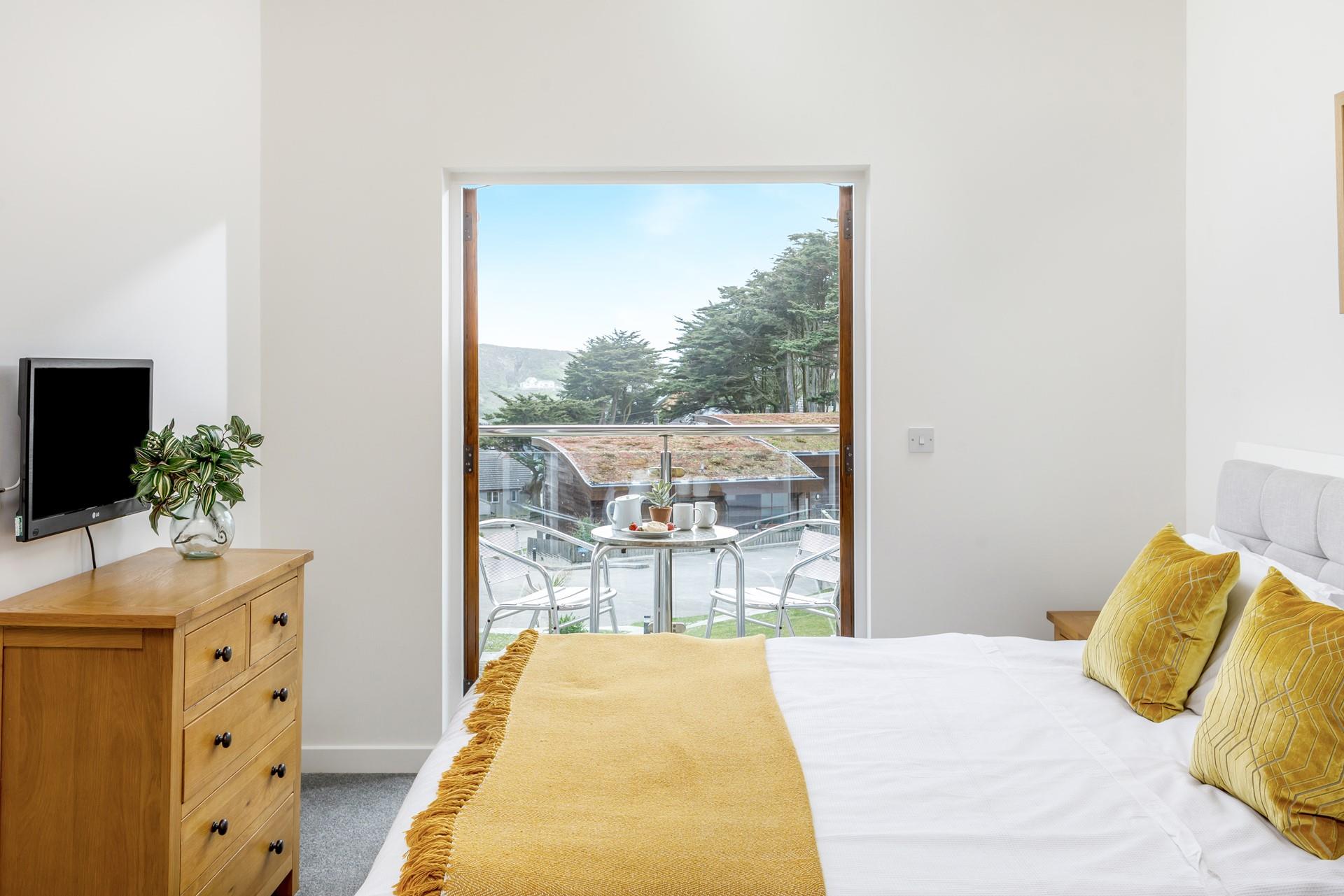 Bedroom 1 boasts a TV, en suite shower and doors to the private balcony for enjoying a morning coffee. 