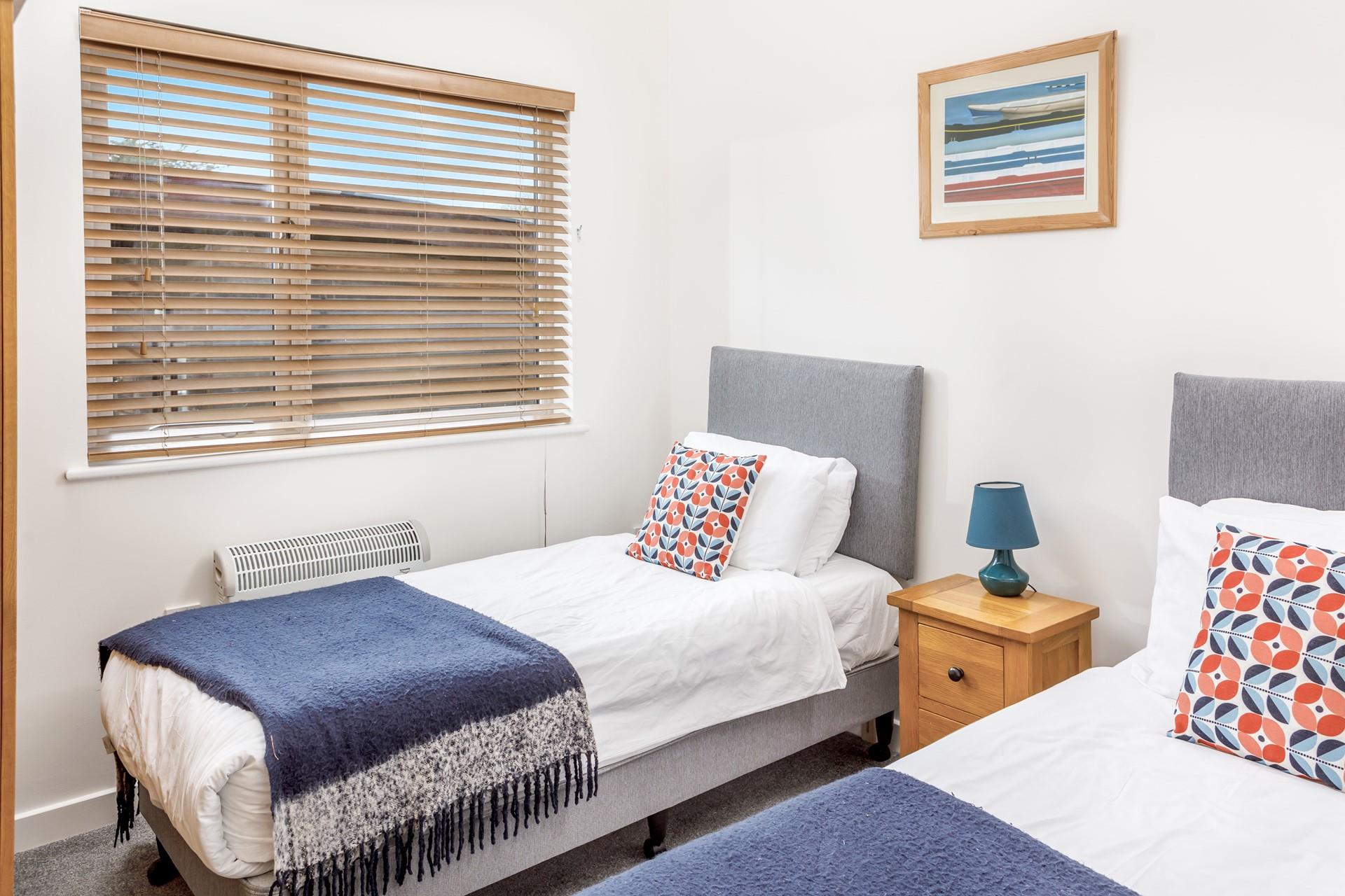 Bedroom 3 has twin beds and is located at the front of the house.