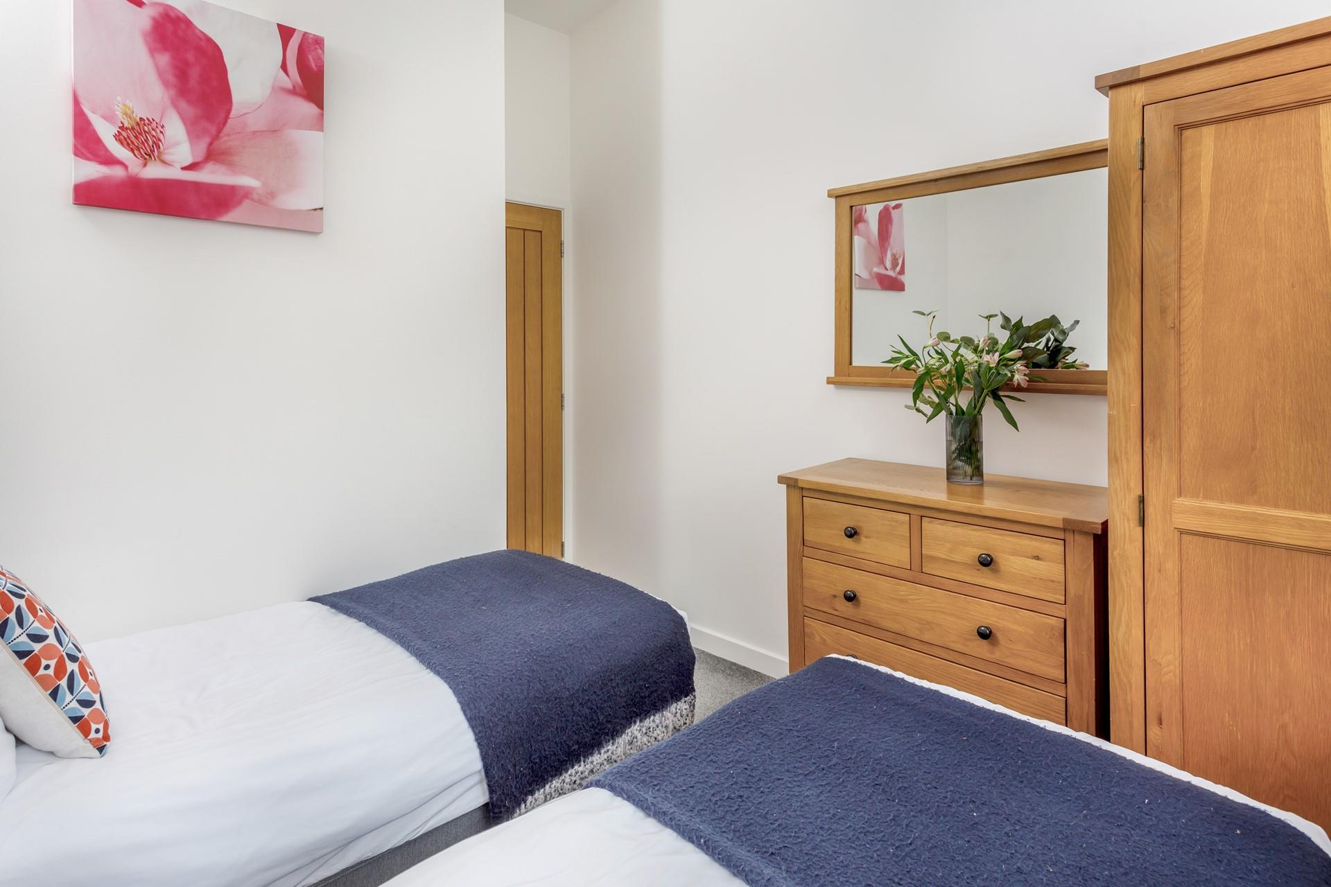 Soft tones, fun prints and lots of storage options make this the perfect room for children!