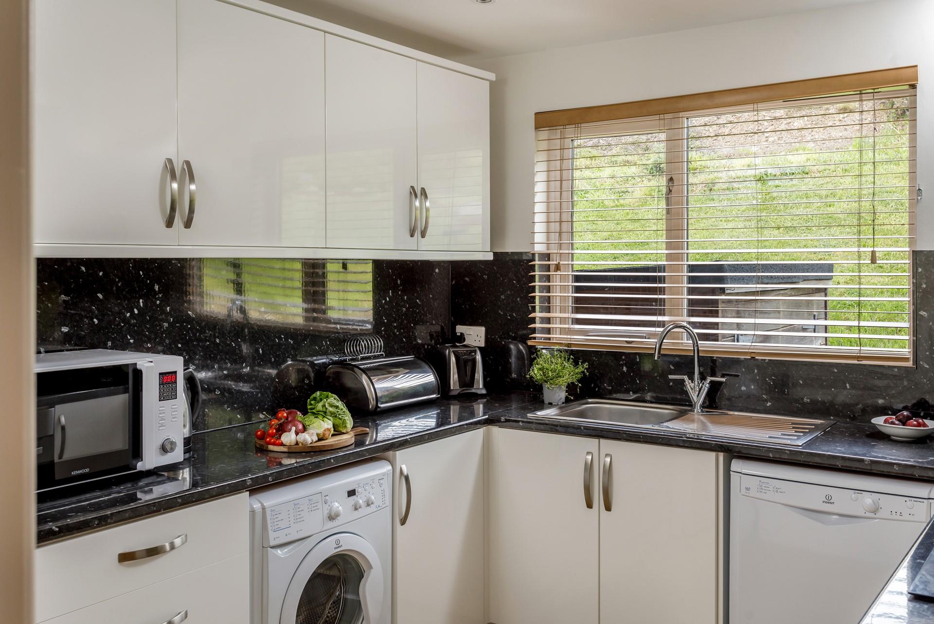 The kitchen has a minimalistic design yet is well-equipped with everything you could need.