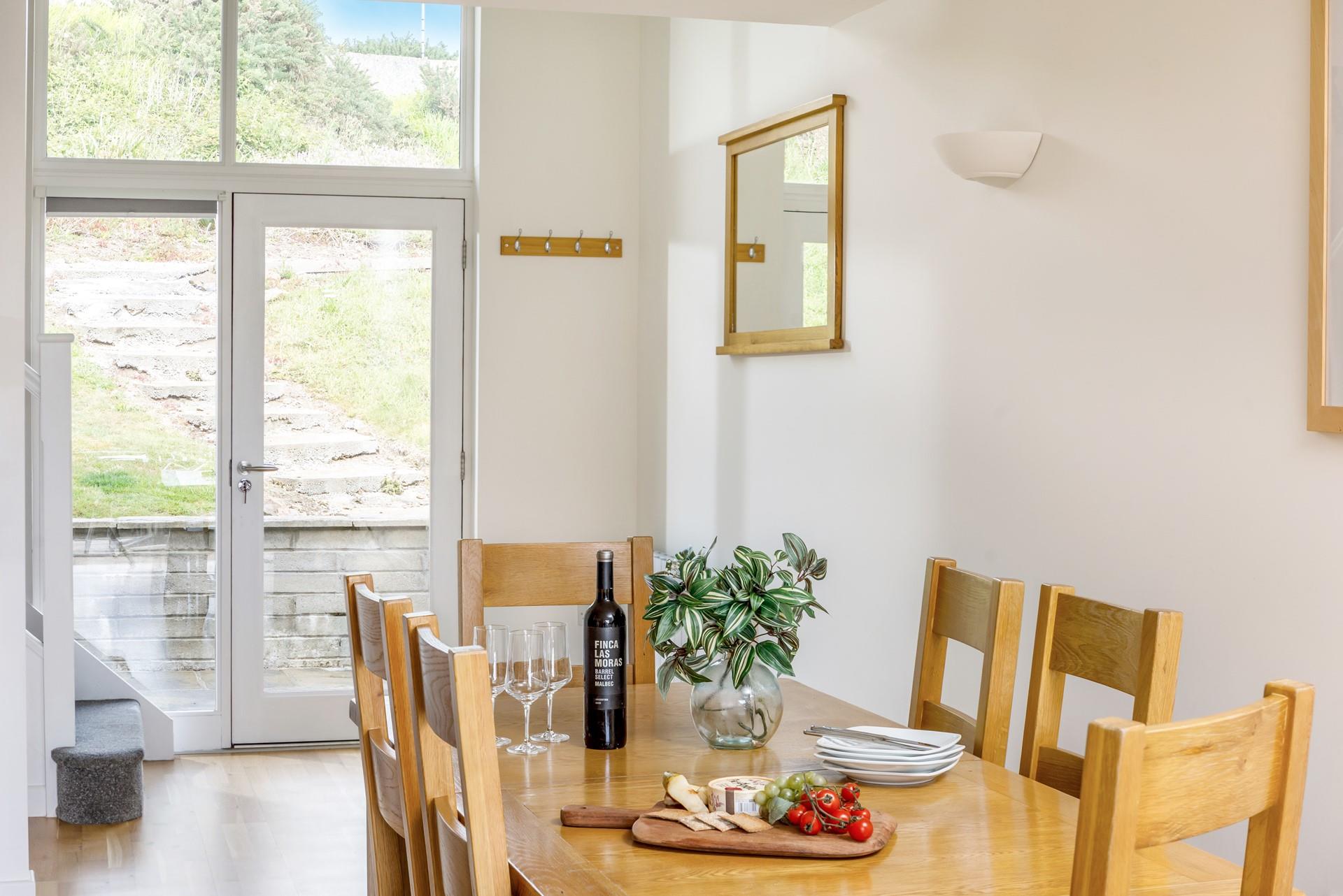 The dining table is light and airy, offering ample space to come together and enjoy home-cooked meals or takeaway treats!