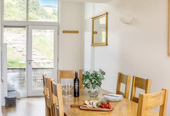 The dining table is light and airy, offering ample space to come together and enjoy home-cooked meals or takeaway treats!