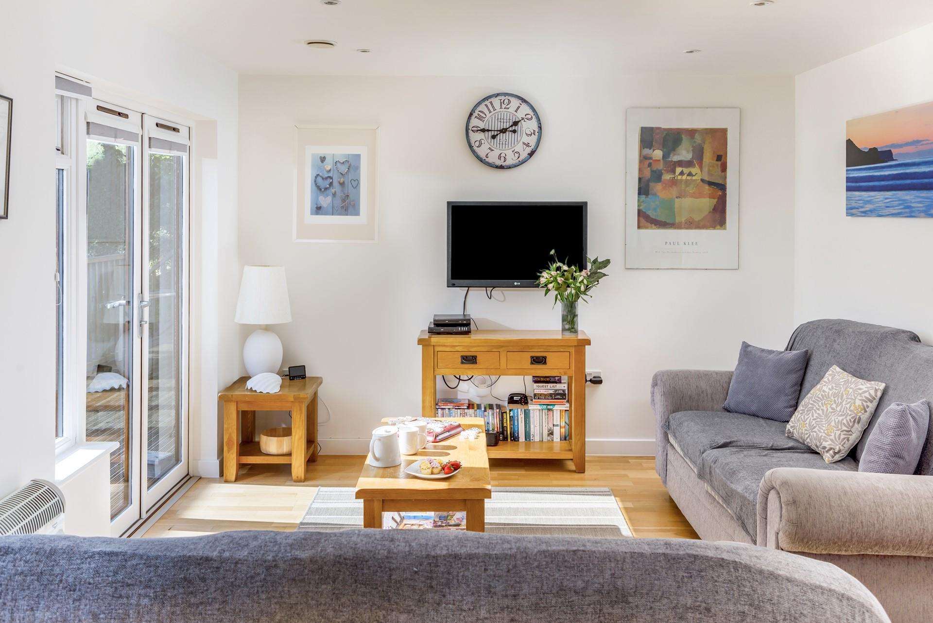 The doors from the sitting area lead out onto the front decked area and are perfect for letting in the fresh air on warm days.