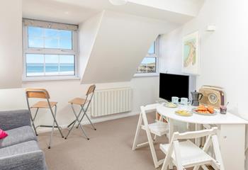 There's a TV and wonderful sea views in this light and airy space. 