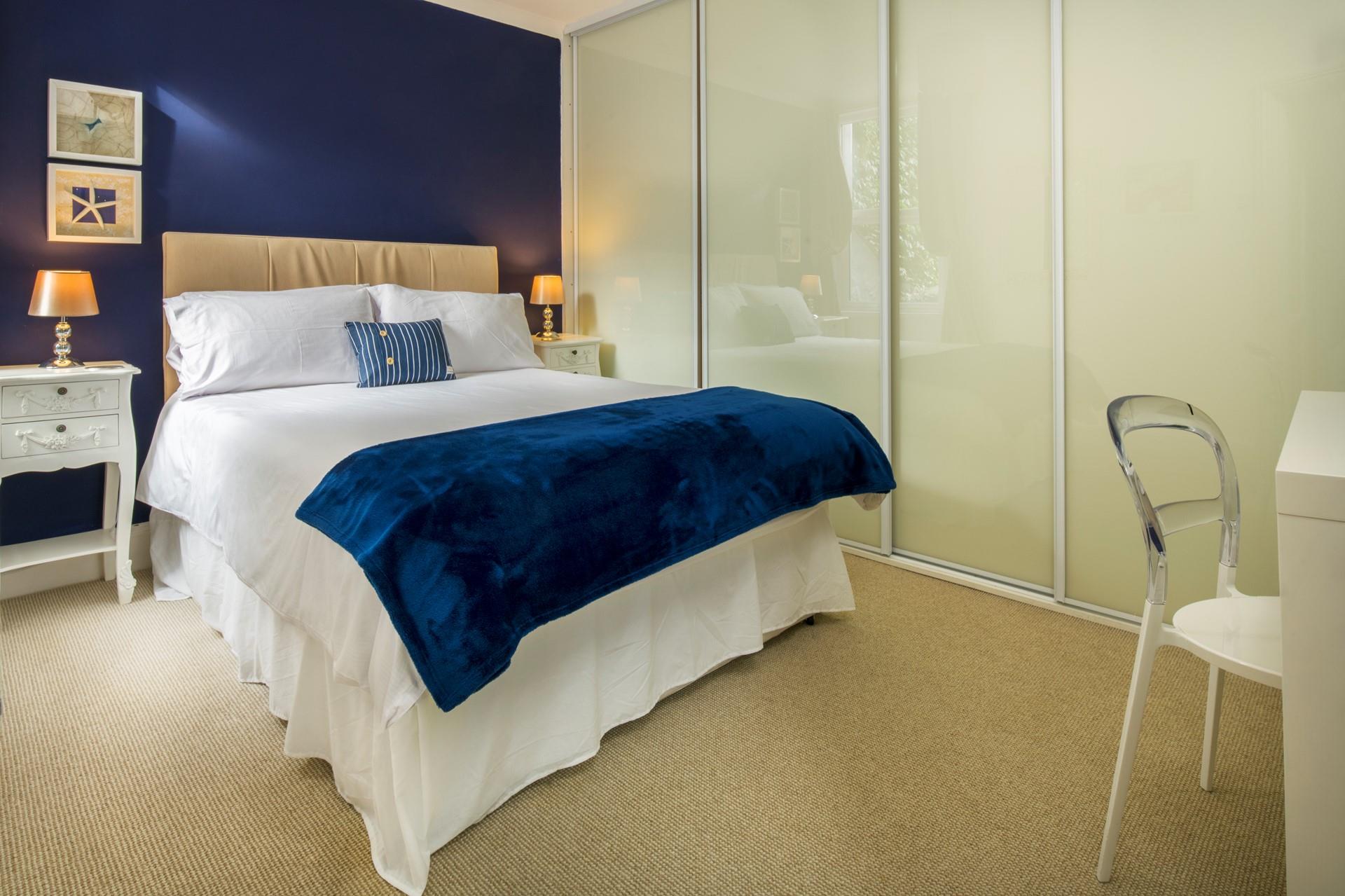 Deep blue creates a beautiful ocean-inspired bedroom.