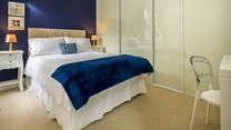 Deep blue creates a beautiful ocean-inspired bedroom.