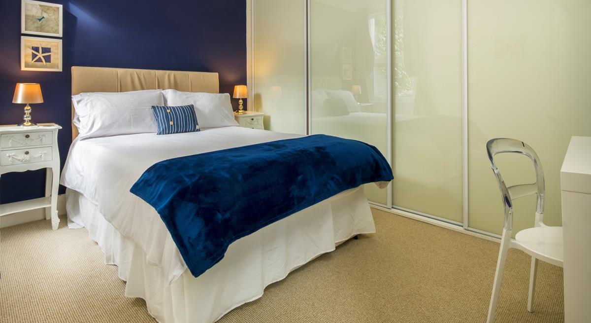 Deep blue creates a beautiful ocean-inspired bedroom.