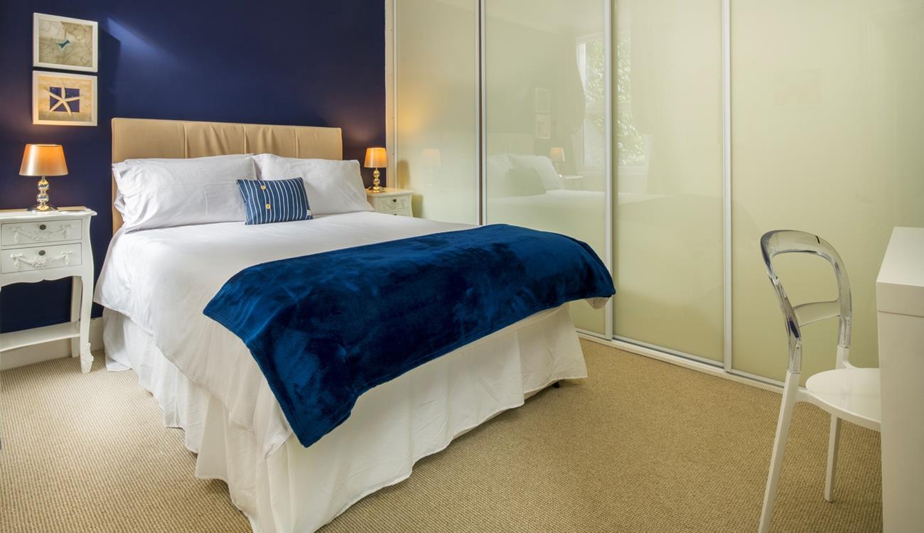 Deep blue creates a beautiful ocean-inspired bedroom.