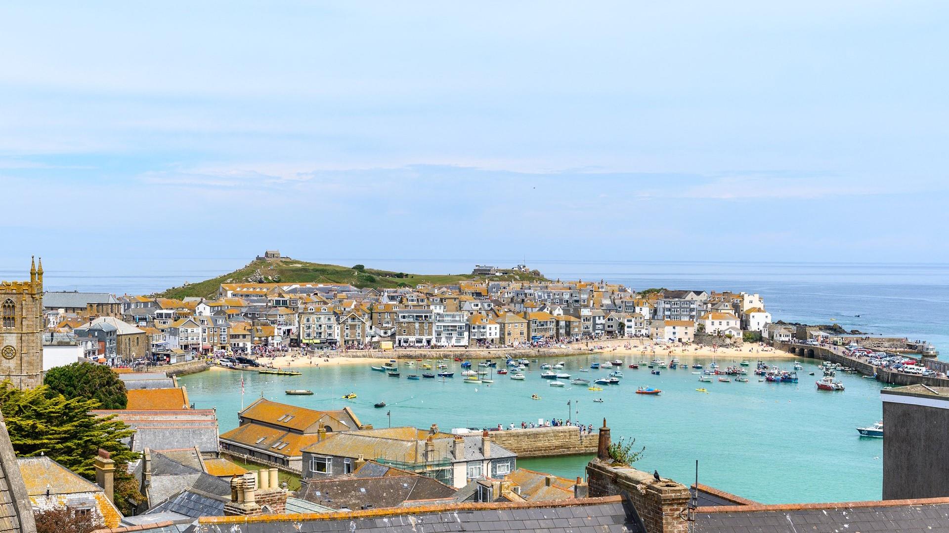Admire the stunning view of St Ives harbour, which showcases the kaleidoscope of ever-changing colours of the sea.