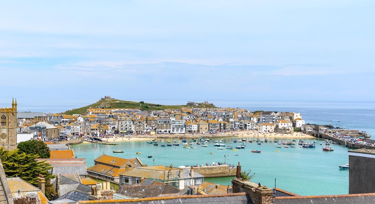 Admire the stunning view of St Ives harbour, which showcases the kaleidoscope of ever-changing colours of the sea.