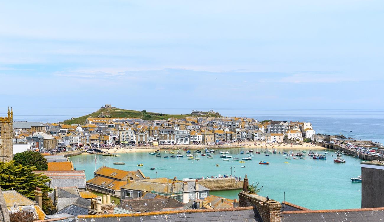 Admire the stunning view of St Ives harbour, which showcases the kaleidoscope of ever-changing colours of the sea.