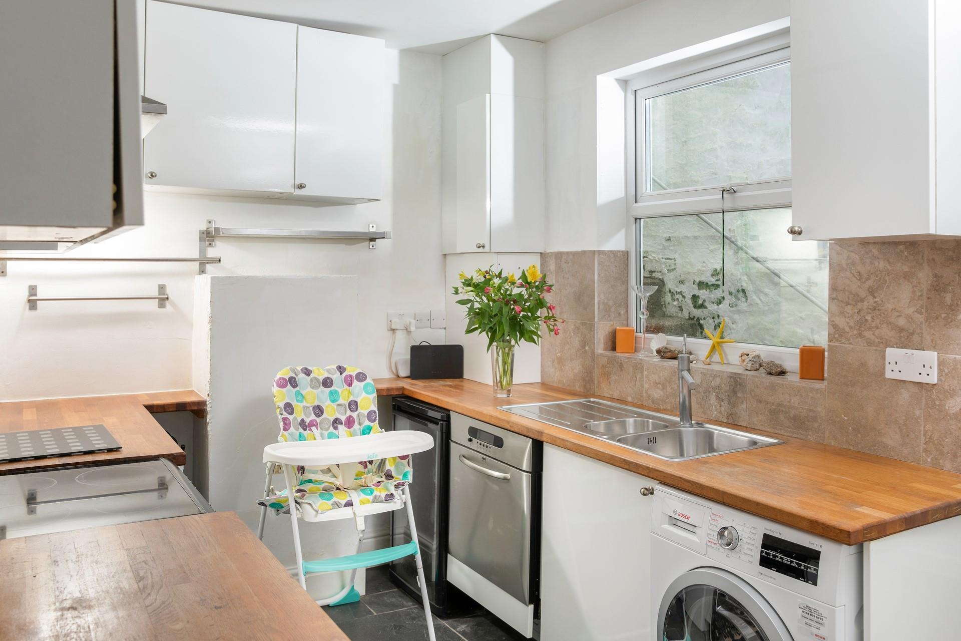 There is a second kitchen/utility room, offering extra space and amenities.