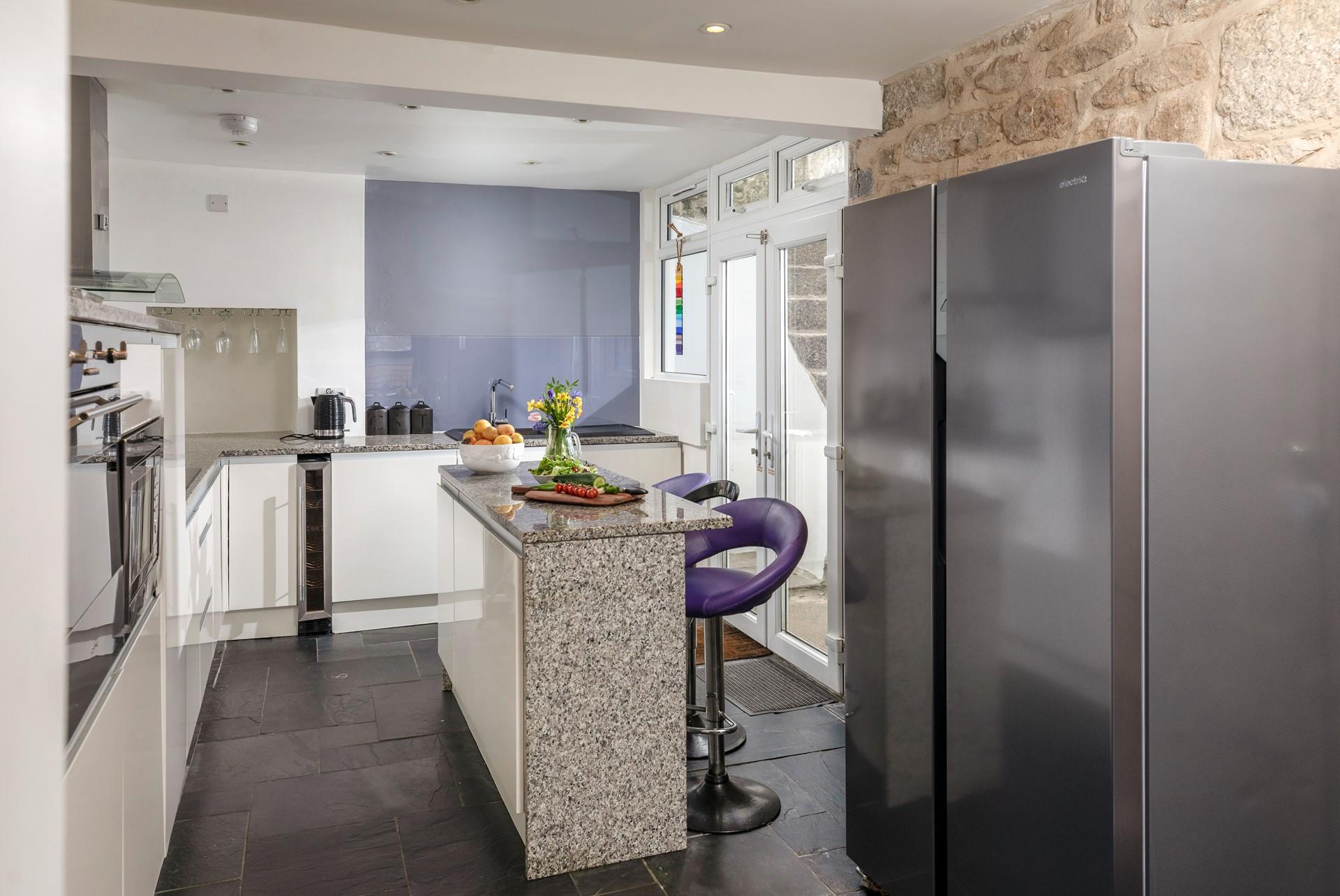 You'll find contemporary style blended with traditional cottage features, like the stone wall in the kitchen.