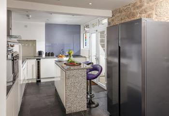 You'll find contemporary style blended with traditional cottage features, like the stone wall in the kitchen.