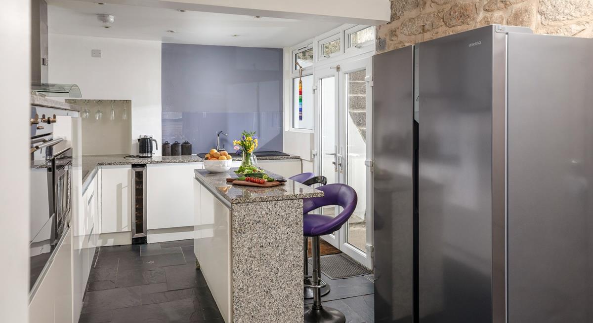 You'll find contemporary style blended with traditional cottage features, like the stone wall in the kitchen.