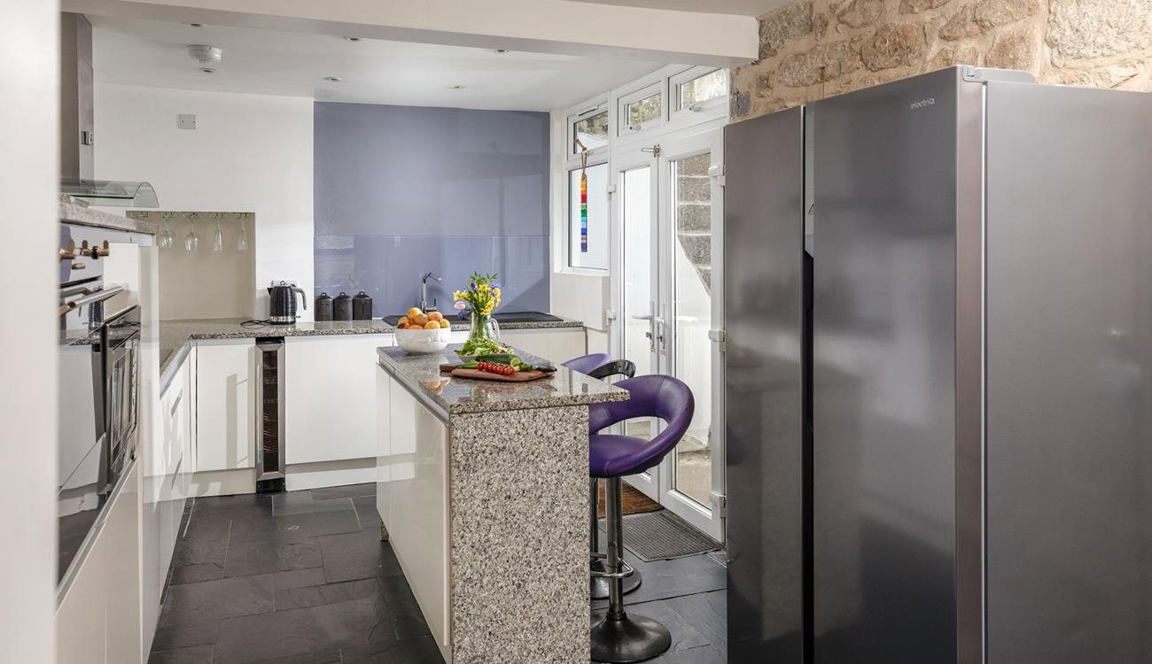 You'll find contemporary style blended with traditional cottage features, like the stone wall in the kitchen.