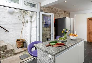 Steps from the kitchen take you out and up to the leafy garden.