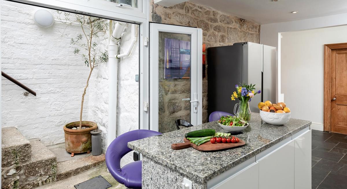 Steps from the kitchen take you out and up to the leafy garden.