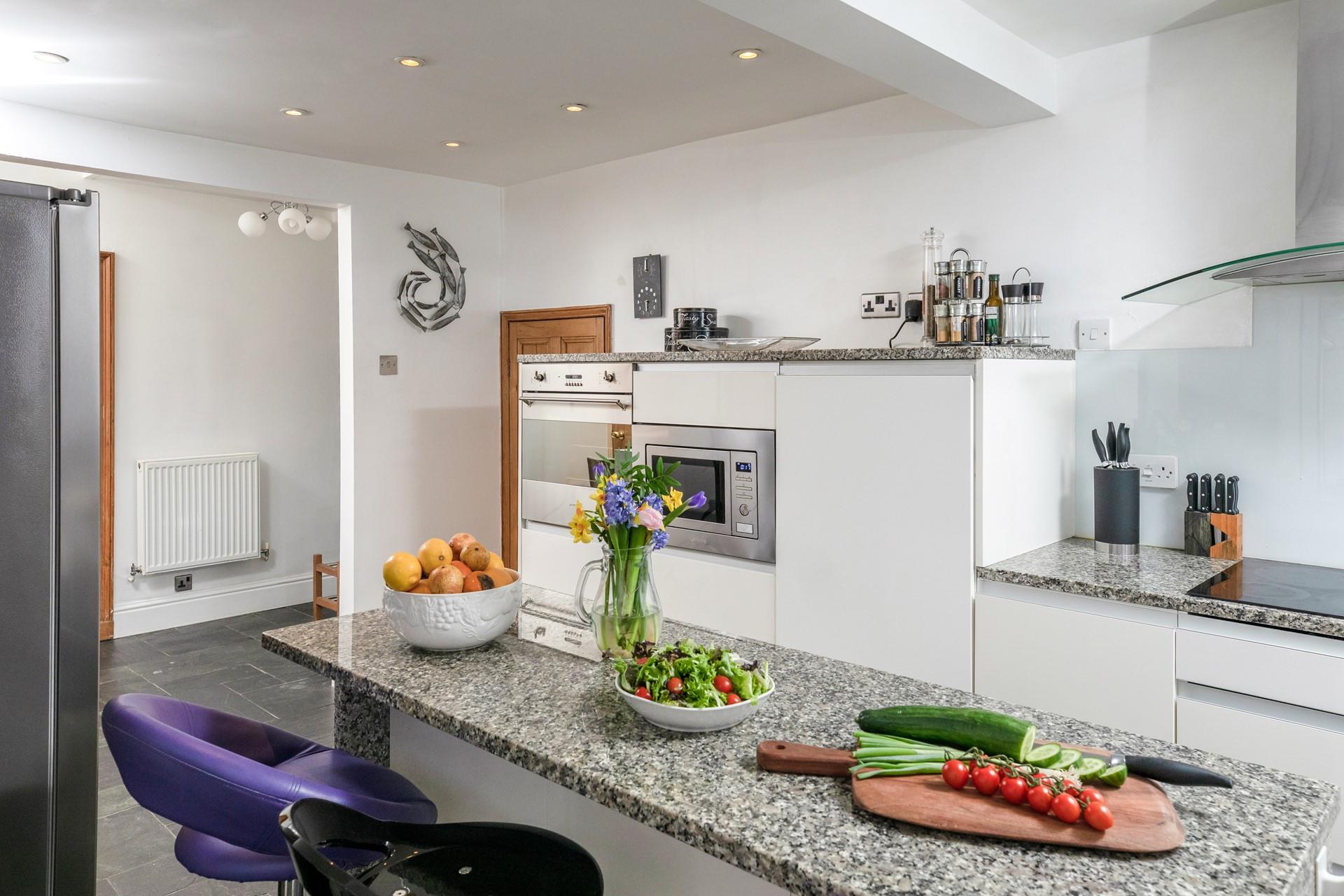 Family and friends can gather around the kitchen island.