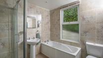 The family bathroom has a walk-in shower and bath. 