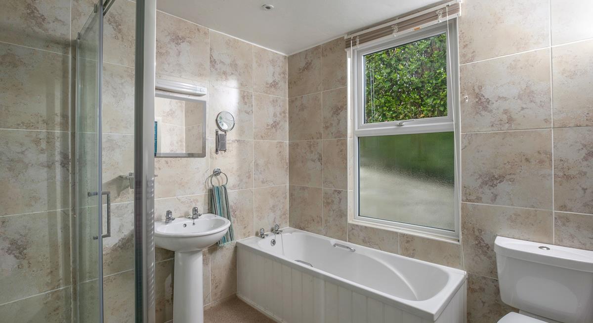 The family bathroom has a walk-in shower and bath. 