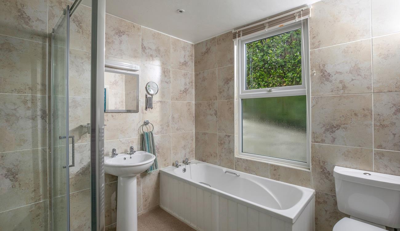 The family bathroom has a walk-in shower and bath. 