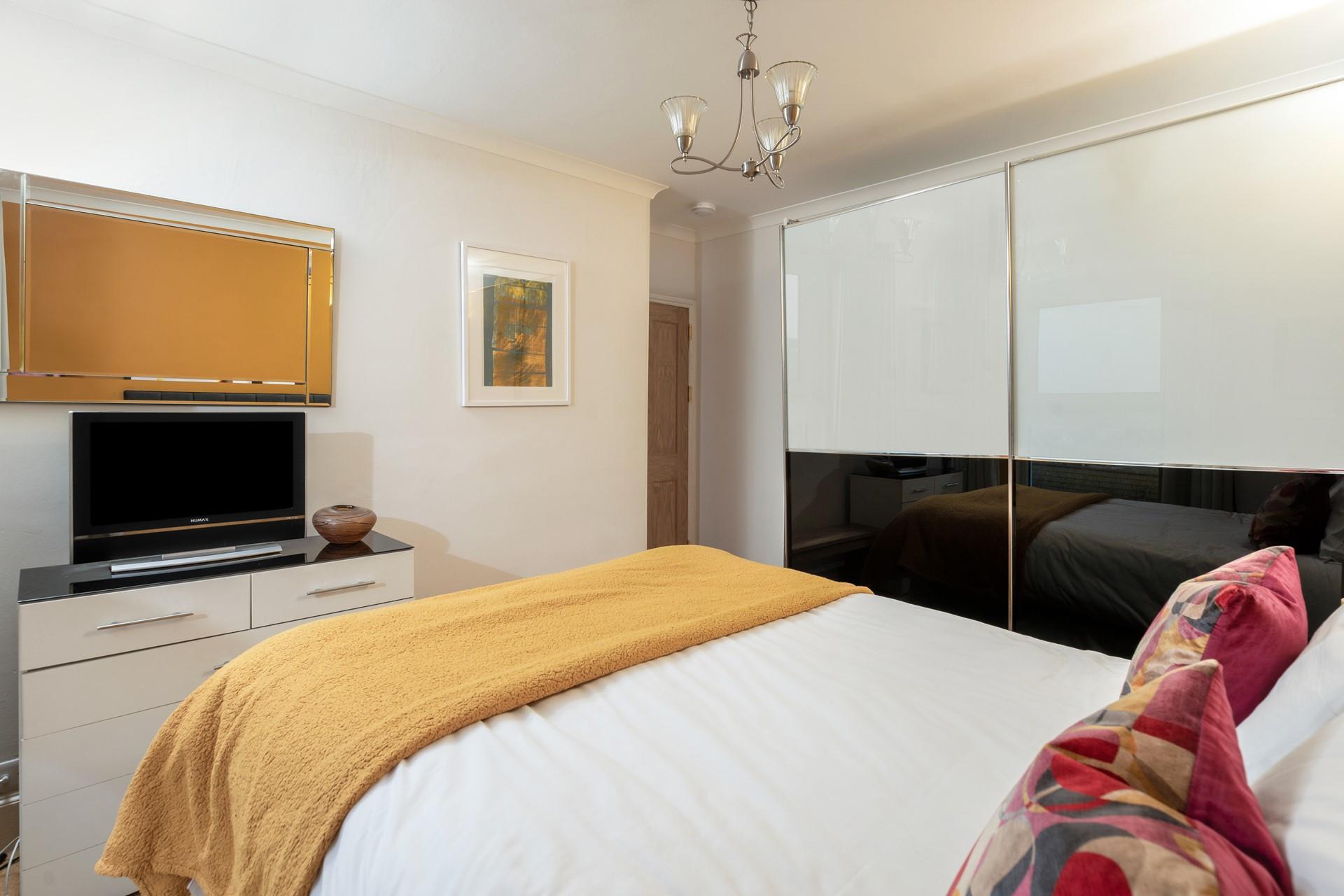 The spacious wardrobe offers plenty of storage.