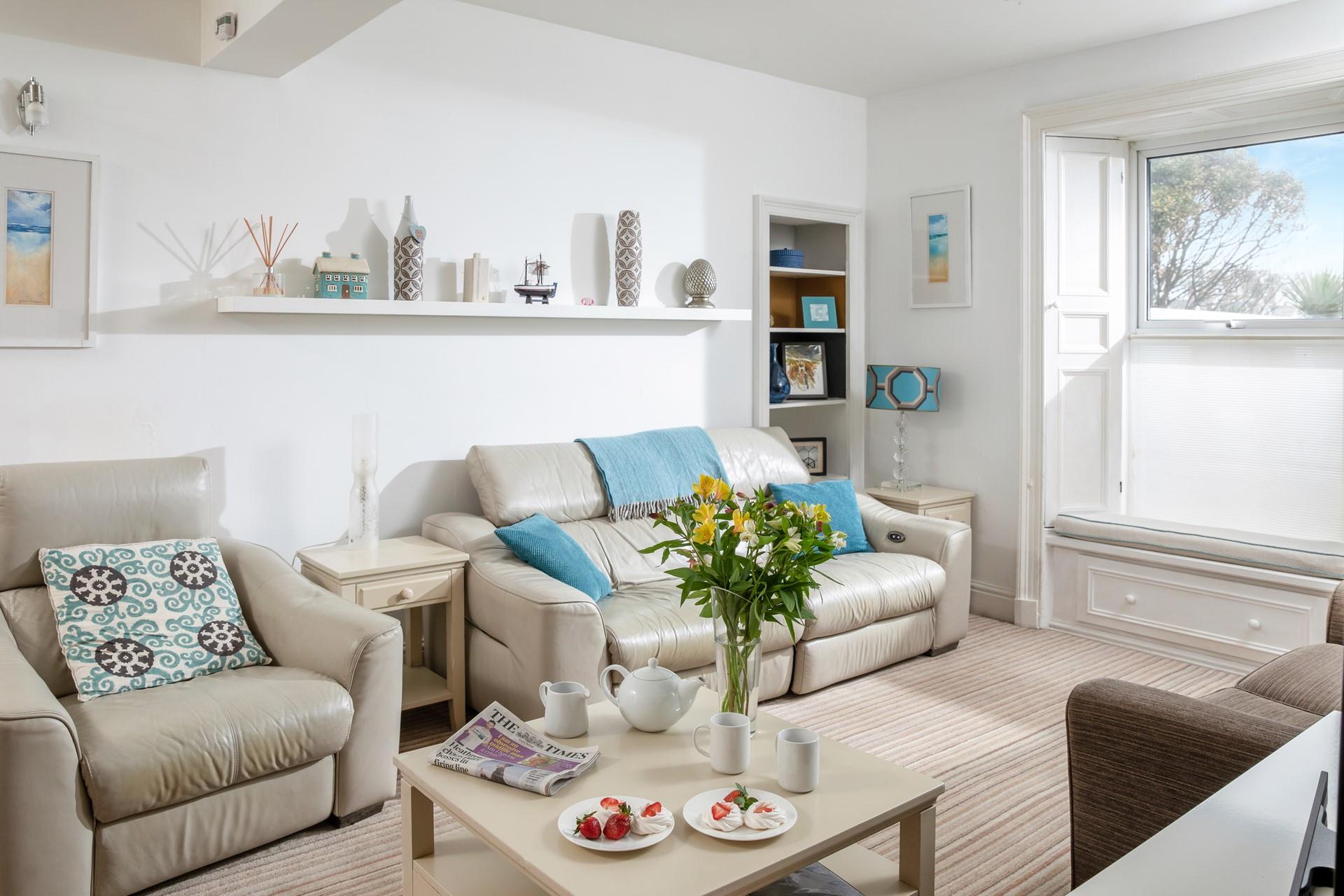 The sitting room is decorated with calming tones of coastal blue.