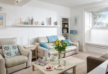The sitting room is decorated with calming tones of coastal blue.
