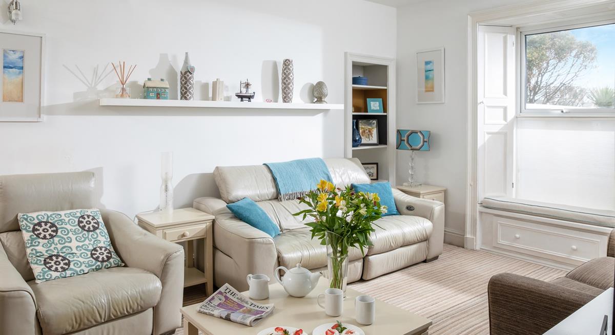 The sitting room is decorated with calming tones of coastal blue.