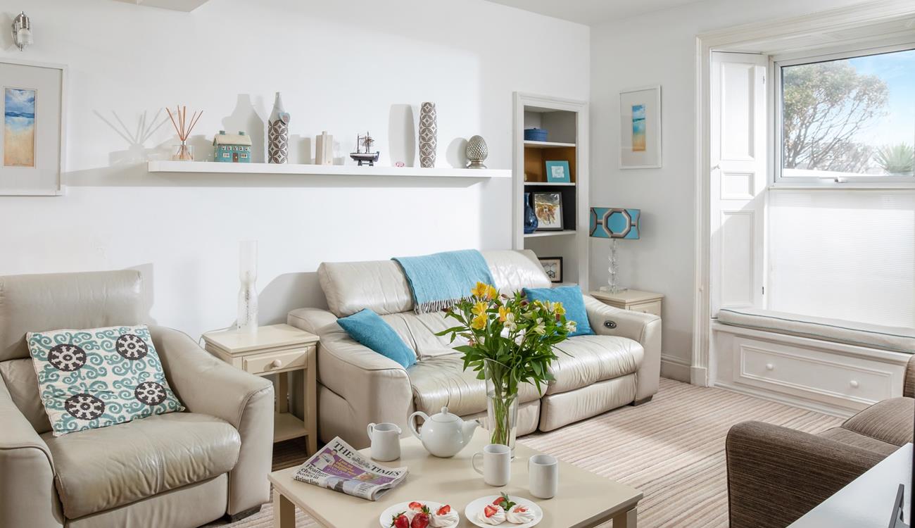 The sitting room is decorated with calming tones of coastal blue.