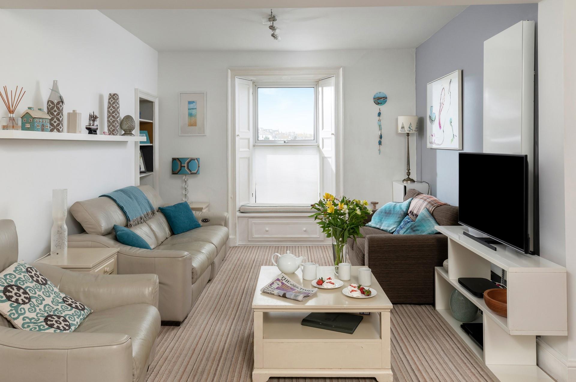 Relax in the sitting room enjoying gorgeous views over the harbour.