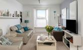 Relax in the sitting room enjoying gorgeous views over the harbour. - Thumbnail Image