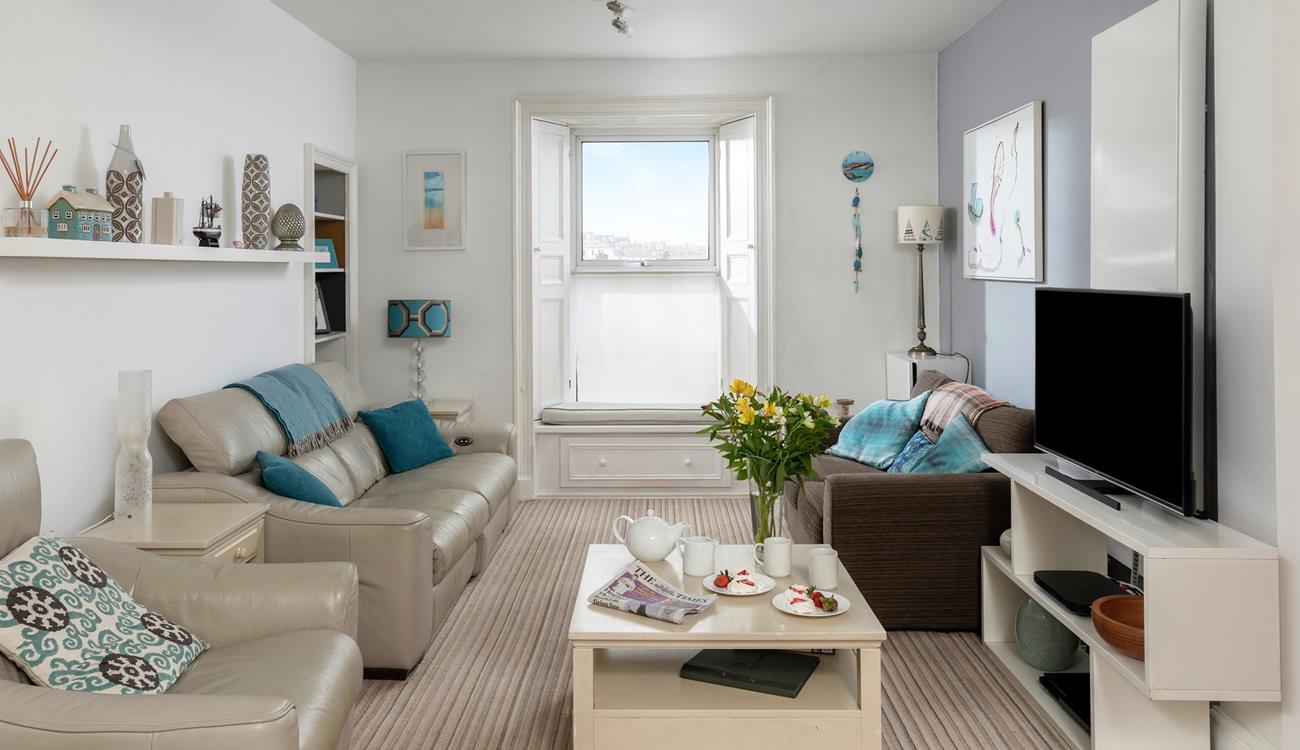 Relax in the sitting room enjoying gorgeous views over the harbour.