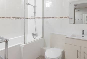 The family bathroom has a well-sized bath and shower for washing off sandy toes.