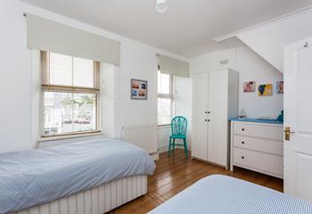 The twin beds and ample storage make this bedroom perfect for both children and adults.