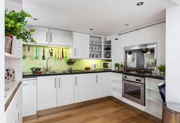 The quirky and modern kitchen is well-equipped to make whipping up delicious feasts easy.