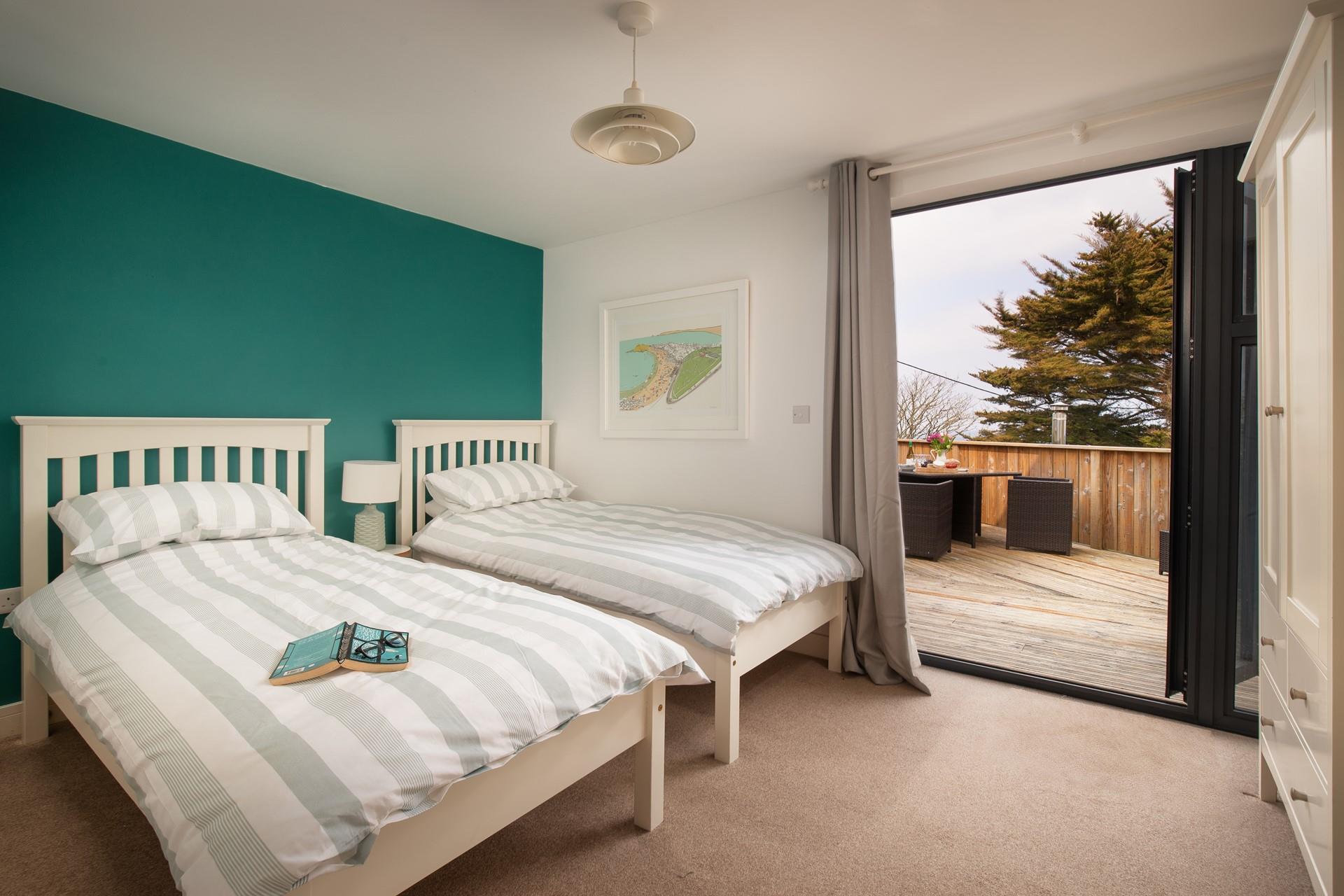 The twin bedroom also offers doors out to the patio.