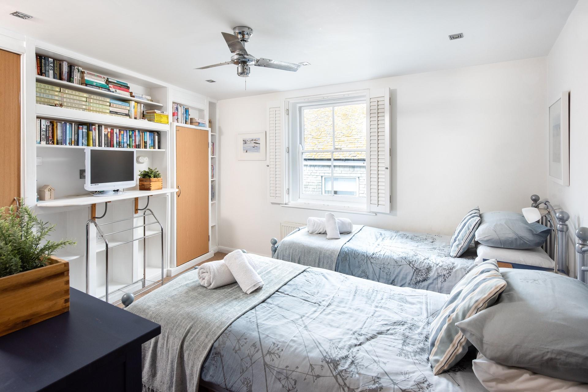 The twin bedroom provides a space for the kids to sleep, exhausted after a day on the beach.