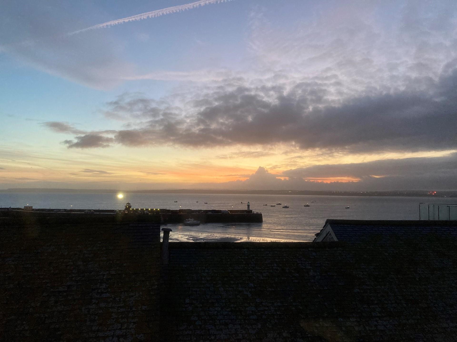 Watch the sunset over the harbour to end the day.