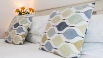 Comfortable furnishings give the bedroom a luxurious feel.