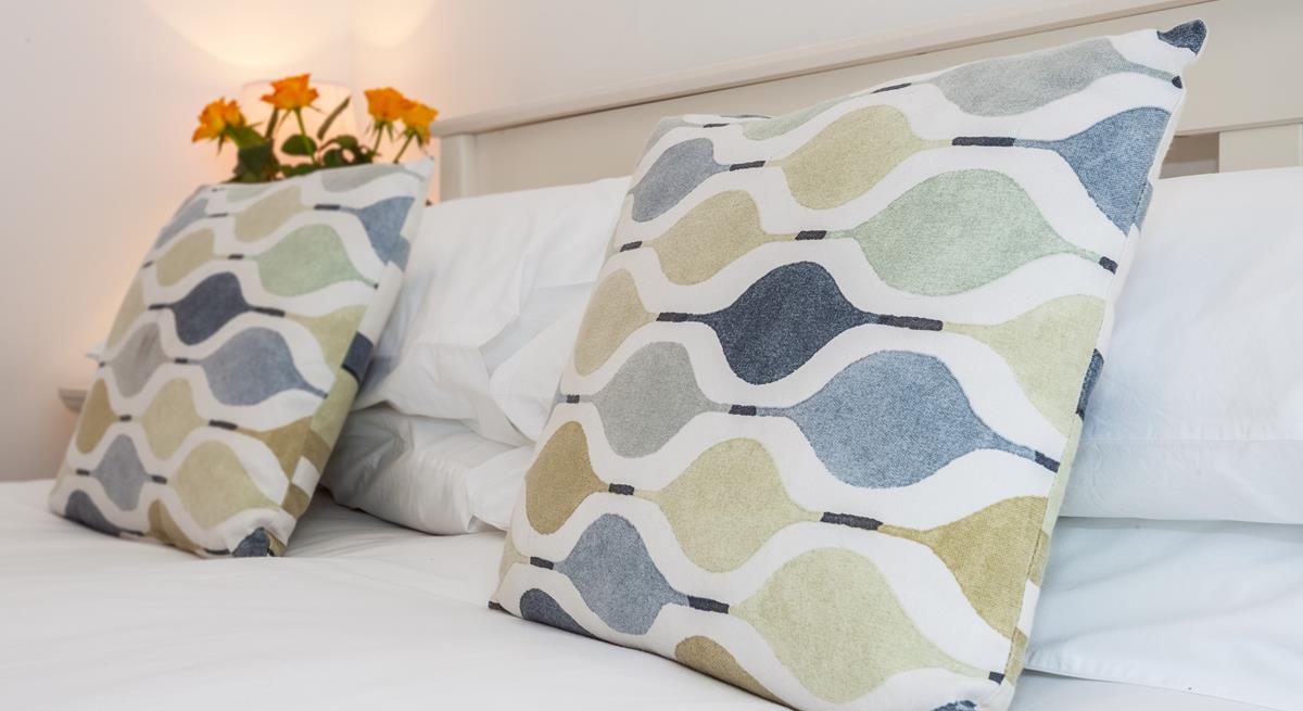 Comfortable furnishings give the bedroom a luxurious feel.