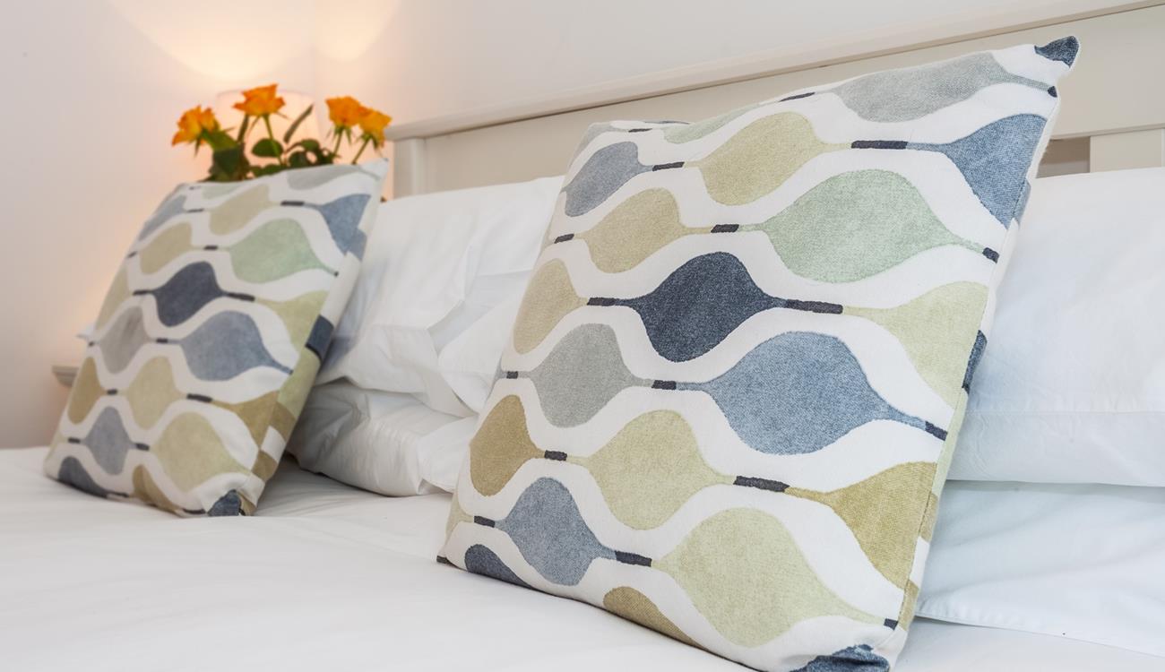 Comfortable furnishings give the bedroom a luxurious feel.